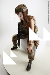 Fighting with gun Woman White Sitting poses - ALL Slim long brown Sitting poses - simple Standard Photoshoot Academic