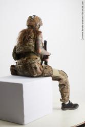 Fighting with gun Woman White Sitting poses - ALL Slim long brown Sitting poses - simple Standard Photoshoot Academic